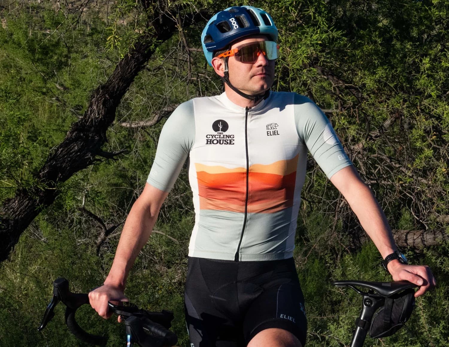 Cyclist with a bicycle wearing the finished desert-tone kit